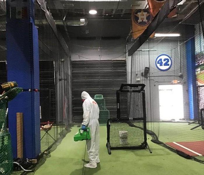 SERVPRO employee in Full PPE fogging for sanitization of a gym facility