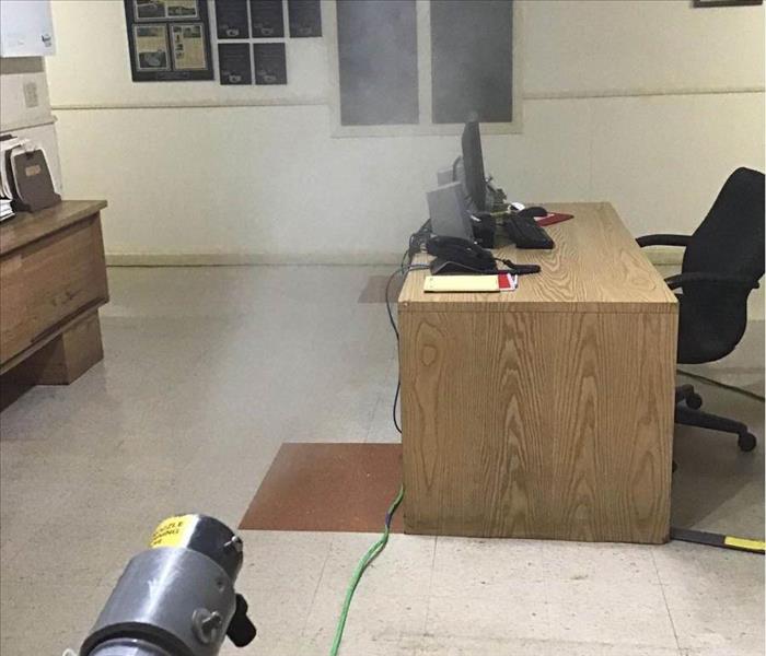 fogging machine being used to disinfect this office to help the employees have a sanitized place to work.