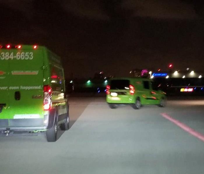 SERVPRO cars driving to site.