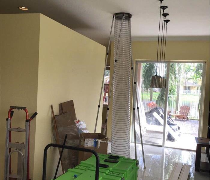 a large tube being used to clean out a Weston home's duct work.